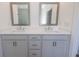 Bathroom featuring double sinks, framed mirrors, white countertops, and neutral cabinetry at 502 Healy Dr # 76, Cumming, GA 30040