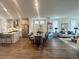 Open-concept layout featuring a modern kitchen flowing into a dining area with elegant seating and decor at 502 Healy Dr # 76, Cumming, GA 30040