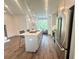 Updated kitchen with stainless steel appliances, white cabinets, and a large center island with seating at 502 Healy Dr # 76, Cumming, GA 30040