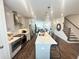 Bright, modern kitchen with stainless steel appliances, island with seating, and adjacent staircase at 502 Healy Dr # 76, Cumming, GA 30040