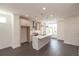 Modern kitchen featuring white cabinetry, stainless steel appliances, and a large island with a quartz countertop at 502 Healy Dr # 76, Cumming, GA 30040