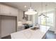Well-designed kitchen with a center island, stainless steel hood, white cabinets, and modern pendant lighting at 502 Healy Dr # 76, Cumming, GA 30040