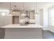 Open concept kitchen with white cabinets, modern pendant lights, stainless steel appliances, and a quartz countertop island at 502 Healy Dr # 76, Cumming, GA 30040