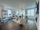 Bright living room with hardwood floors, modern lighting, large windows, and contemporary furnishings at 502 Healy Dr # 76, Cumming, GA 30040