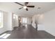 Open-concept living room features dark wood floors, white trim, and a ceiling fan at 502 Healy Dr # 76, Cumming, GA 30040