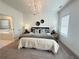 Main bedroom with carpeted floors, decorative wall trim, and modern chandelier at 502 Healy Dr # 76, Cumming, GA 30040