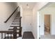 Staircase features hardwood steps with a dark wood railing and a conveniently located bathroom on the main level at 502 Healy Dr # 76, Cumming, GA 30040