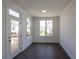 Bright sun room with dark wood floors, lots of natural light, and a door to the deck at 502 Healy Dr # 76, Cumming, GA 30040