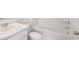 A modern bathroom featuring a white vanity with sink, toilet, and bathtub/shower combo at 637 Kimberwick Dr, Locust Grove, GA 30248