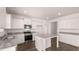 Bright kitchen with white cabinetry, granite countertops, and stainless steel appliances at 637 Kimberwick Dr, Locust Grove, GA 30248