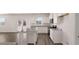 Updated kitchen with white cabinets, stainless appliances, island and granite countertops, offering a sleek culinary space at 637 Kimberwick Dr, Locust Grove, GA 30248