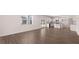 Open-concept living room with wood floors, leading into the kitchen and dining area at 637 Kimberwick Dr, Locust Grove, GA 30248