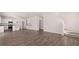 Spacious open-concept living space featuring wood floors and a modern kitchen with stainless appliances at 637 Kimberwick Dr, Locust Grove, GA 30248