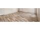 An empty bedroom with light wood laminate flooring at 9066 Bob Jackson Dr, Jonesboro, GA 30238