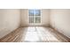 A bedroom with a large window providing natural light on laminate flooring at 9066 Bob Jackson Dr, Jonesboro, GA 30238