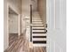 Bright entryway with staircase and wood-look flooring leads to a welcoming interior at 9066 Bob Jackson Dr, Jonesboro, GA 30238