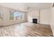 Bright living area with wood-look flooring and a fireplace makes this home inviting at 9066 Bob Jackson Dr, Jonesboro, GA 30238