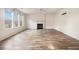 Open living area featuring light hardwood-style floors, fireplace and large windows at 9066 Bob Jackson Dr, Jonesboro, GA 30238