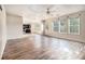 Bright open-concept living space with wood-style flooring, seamlessly connected to the kitchen at 9066 Bob Jackson Dr, Jonesboro, GA 30238