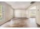 Bright living room featuring wood-look floors and multiple windows at 9066 Bob Jackson Dr, Jonesboro, GA 30238