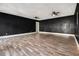 Large living room featuring ceiling fans and black painted walls at 9066 Bob Jackson Dr, Jonesboro, GA 30238