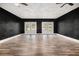 Spacious living room featuring ceiling fans and black accent wall at 9066 Bob Jackson Dr, Jonesboro, GA 30238