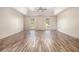 Spacious main bedroom featuring tray ceilings, ceiling fan, and wood-look flooring at 9066 Bob Jackson Dr, Jonesboro, GA 30238