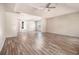 Bright main bedroom featuring tray ceilings, ceiling fan, and wood-look flooring at 9066 Bob Jackson Dr, Jonesboro, GA 30238