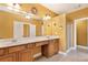 Bathroom featuring a large vanity with double sinks and stylish light fixtures at 275 Blue Pointe Ct, Suwanee, GA 30024