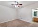Bedroom with a ceiling fan, a closet door, a door to the bathroom, and carpeted floors at 275 Blue Pointe Ct, Suwanee, GA 30024