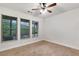 Bedroom with light walls, ceiling fan, carpet, and windows with mini blinds allowing plenty of natural light at 275 Blue Pointe Ct, Suwanee, GA 30024