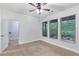 Bedroom with light walls, ceiling fan, carpet, and windows with mini blinds allowing plenty of natural light at 275 Blue Pointe Ct, Suwanee, GA 30024