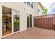 A rear-facing deck overlooks a kitchen with stainless steel appliances and wood cabinets at 275 Blue Pointe Ct, Suwanee, GA 30024