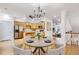 Dining area featuring an adjacent kitchen, hardwood floors, a chandelier, and seamless flow to the living area at 275 Blue Pointe Ct, Suwanee, GA 30024