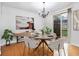 Dining room with hardwood floors, stylish chandelier, sliding glass door, modern decor, and plants at 275 Blue Pointe Ct, Suwanee, GA 30024