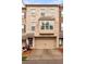 Charming brick townhouse with a two-car garage and a bay window feature at 275 Blue Pointe Ct, Suwanee, GA 30024