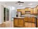 Well-lit kitchen with wooden cabinets, stainless steel appliances, an island, and access to the outdoor deck at 275 Blue Pointe Ct, Suwanee, GA 30024