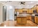 Kitchen featuring wood cabinets, stainless steel appliances, a center island, and sliding glass door at 275 Blue Pointe Ct, Suwanee, GA 30024