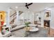 Bright living room with modern decor, fireplace, staircase, and large windows for natural light at 275 Blue Pointe Ct, Suwanee, GA 30024