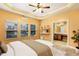 Bright main bedroom featuring large windows, open shelves, and a view to the main bathroom at 275 Blue Pointe Ct, Suwanee, GA 30024
