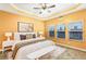 Spacious main bedroom with tray ceiling, ceiling fan, and multiple windows at 275 Blue Pointe Ct, Suwanee, GA 30024
