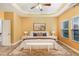 Inviting main bedroom with tray ceiling, ceiling fan, and large windows at 275 Blue Pointe Ct, Suwanee, GA 30024
