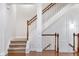 Elegant staircase with white railing and wooden trim, complemented by carpeted steps, and hardwood floors at 275 Blue Pointe Ct, Suwanee, GA 30024