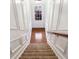Carpeted staircase with white trim leading to an exterior door and hardwood flooring at 275 Blue Pointe Ct, Suwanee, GA 30024