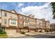 Street view of brick townhomes showcasing well-maintained landscaping and consistent architecture at 275 Blue Pointe Ct, Suwanee, GA 30024