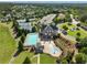 Expansive aerial view showcasing the community pool, clubhouse, tennis courts and lush landscaping of this neighborhood at 3786 Alstead Manor Way, Suwanee, GA 30024