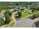 Aerial of community pool, tennis and clubhouse, with mature trees, water features and manicured lawns at 3786 Alstead Manor Way, Suwanee, GA 30024