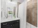 Well-maintained bathroom with shower-tub combo, vanity, and stylish neutral toned tiles at 3786 Alstead Manor Way, Suwanee, GA 30024