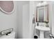 Stylish powder room with pedestal sink, modern fixtures, and decorative accents at 3786 Alstead Manor Way, Suwanee, GA 30024