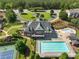 Aerial view of a large community pool, clubhouse, and tennis court at 3786 Alstead Manor Way, Suwanee, GA 30024